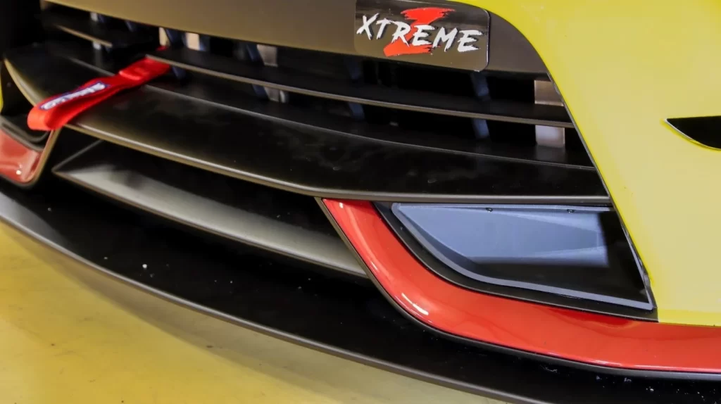 Front end of a Nissan 370Z with a carbon fiber brake air duct insert