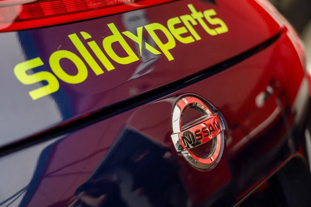 The Solidxperts logo on the nose of a Nissan 370z race car